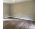 A bright bedroom features laminate flooring and neutral walls with bright white trim at 1327 Wiscassett St, Albemarle, NC 28001