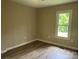 A bright bedroom features laminate flooring and neutral walls with a bright window at 1327 Wiscassett St, Albemarle, NC 28001