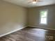 A bright bedroom features laminate flooring and neutral walls with a bright window at 1327 Wiscassett St, Albemarle, NC 28001