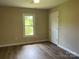 A bright bedroom features laminate flooring and neutral walls with a bright window at 1327 Wiscassett St, Albemarle, NC 28001