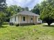A quaint home with neutral-colored siding and a well-manicured lawn at 1327 Wiscassett St, Albemarle, NC 28001