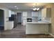 Bright kitchen featuring white cabinets, granite countertops, and stainless steel appliances at 1327 Wiscassett St, Albemarle, NC 28001