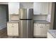 Kitchen featuring stainless steel refrigerator and white cabinetry with granite countertops at 1327 Wiscassett St, Albemarle, NC 28001