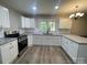 Updated kitchen with white cabinets, granite countertops, and stainless steel appliances at 1327 Wiscassett St, Albemarle, NC 28001