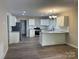 Bright kitchen featuring white cabinets, granite countertops, and stainless steel appliances at 1327 Wiscassett St, Albemarle, NC 28001