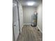 Utility Room featuring wood-look floors and a new hot water heater at 1327 Wiscassett St, Albemarle, NC 28001