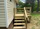 New wooden deck and steps lead into the backyard at 1327 Wiscassett St, Albemarle, NC 28001
