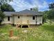 Exterior of home showing backyard with new wooden porch and steps at 1327 Wiscassett St, Albemarle, NC 28001