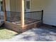 Close up of the front porch featuring black metal railings and stained wood base at 1327 Wiscassett St, Albemarle, NC 28001