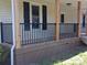 Close up of the front porch featuring black metal railings and stained wood base at 1327 Wiscassett St, Albemarle, NC 28001