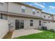 Backyard featuring a concrete patio, grassy area, and sliding glass doors at 138 Lanyard Dr # B, Mooresville, NC 28117