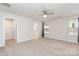 Comfortable bedroom with neutral carpeting, a ceiling fan, and a window providing natural light at 138 Lanyard Dr # B, Mooresville, NC 28117