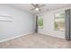 Comfortable bedroom featuring carpeted floors, two windows, and a ceiling fan at 138 Lanyard Dr # B, Mooresville, NC 28117