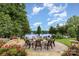 Scenic lakeside firepit area with stone patio, seating, and landscaping at 138 Lanyard Dr # B, Mooresville, NC 28117
