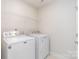 Laundry room featuring a white washer and dryer and wire shelving at 138 Lanyard Dr # B, Mooresville, NC 28117