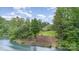 Lush landscaped yard slopes to the waterfront with path and steps to the lake at 138 Lanyard Dr # B, Mooresville, NC 28117
