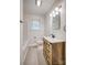 Bathroom features a wooden vanity, clean lines, a white bathtub, and neutral color scheme at 1503 Brentwood Dr, Newton, NC 28658