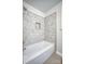 Close-up of a bathroom showing hexagon tile shower, bathtub and metallic trim at 1503 Brentwood Dr, Newton, NC 28658