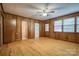 Bedroom with wood paneling, hardwood floors, and natural light at 1503 Brentwood Dr, Newton, NC 28658