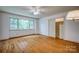 Bright bedroom with hardwood floors, large window, closet, and ceiling fan at 1503 Brentwood Dr, Newton, NC 28658