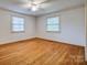 Bedroom with hardwood floors, two windows with blinds, and a ceiling fan at 1503 Brentwood Dr, Newton, NC 28658