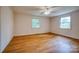 Bedroom with hardwood floors, two windows, and a ceiling fan at 1503 Brentwood Dr, Newton, NC 28658