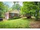 Traditional brick home with a detached garage, lush lawn, trimmed hedges, and mature trees at 1503 Brentwood Dr, Newton, NC 28658