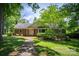 Traditional brick home boasts a welcoming brick walkway and lush landscaping under a beautiful blue sky at 1503 Brentwood Dr, Newton, NC 28658