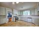 Traditional kitchen with white cabinetry, stainless steel appliances, and unique flooring at 1503 Brentwood Dr, Newton, NC 28658