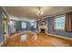 Spacious living room with blue walls, hardwood floors, fireplace, and an elegant chandelier at 1503 Brentwood Dr, Newton, NC 28658