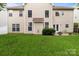 Rear view of home with multiple windows, a patio, and a well-maintained lawn at 1572 Edenton Nw St, Concord, NC 28027