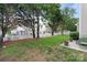 Spacious backyard with a white picket fence, mature trees, and a well-kept lawn, creating a serene outdoor space at 1572 Edenton Nw St, Concord, NC 28027