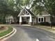 Inviting clubhouse with stone accents, elegant entry, and mature landscaping creates a welcoming community gathering space at 1572 Edenton Nw St, Concord, NC 28027