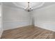 Formal dining room featuring decorative molding, a chandelier, and hardwood flooring at 1572 Edenton Nw St, Concord, NC 28027