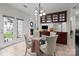 An open dining space is naturally illuminated and transitions to the outdoors through glass doors at 1572 Edenton Nw St, Concord, NC 28027