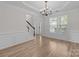 Formal dining room featuring decorative molding, a chandelier, and hardwood flooring at 1572 Edenton Nw St, Concord, NC 28027