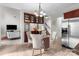 Dining area features stylish chairs, a decorative chandelier, and stainless steel refrigerator at 1572 Edenton Nw St, Concord, NC 28027
