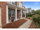 Charming front porch featuring classic columns, a seating area, and meticulously maintained landscaping at 1572 Edenton Nw St, Concord, NC 28027