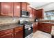 Modern kitchen with stainless steel appliances, granite counters, and ample cabinet space at 1572 Edenton Nw St, Concord, NC 28027