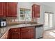 Well-lit kitchen features a stainless steel sink under a window and modern appliances at 1572 Edenton Nw St, Concord, NC 28027