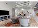 Bright living room featuring a vaulted ceiling, a staircase, and an open floor plan at 1572 Edenton Nw St, Concord, NC 28027