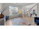 Bright living room with large window, hardwood floors and stylish decor at 1572 Edenton Nw St, Concord, NC 28027
