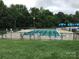 Large community pool surrounded by lounge chairs and lush greenery, perfect for relaxation and recreation at 1572 Edenton Nw St, Concord, NC 28027