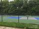 Well-maintained tennis courts with green and blue surfaces, providing residents with recreational opportunities at 1572 Edenton Nw St, Concord, NC 28027