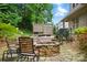 Landscaped backyard featuring a stone fire pit, outdoor furniture, and a wooden deck at 1705 Townsend Ln, Rock Hill, SC 29730