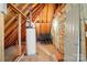 Unfinished basement area with a water heater, exposed beams, and a closed door at 1705 Townsend Ln, Rock Hill, SC 29730