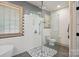 Spa-like bathroom showcasing a frameless glass shower, pebble tile flooring, subway tile walls, and modern fixtures at 1705 Townsend Ln, Rock Hill, SC 29730