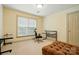 Bedroom with plush tan carpet, a brown futon, a sleek glass desk and a bright sunny window at 1705 Townsend Ln, Rock Hill, SC 29730