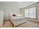 Bright bedroom with a cozy bed, natural light, and a minimalist design at 1705 Townsend Ln, Rock Hill, SC 29730