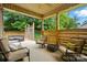 Inviting covered porch features comfortable seating, privacy screens, and a wooded view at 1705 Townsend Ln, Rock Hill, SC 29730